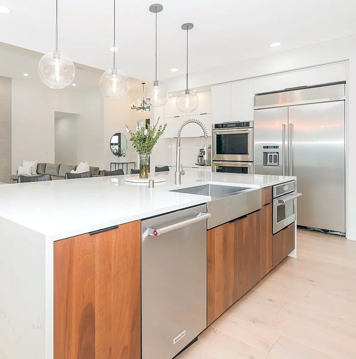 Modern kitchen with an island, built-in wall ovens and a large refrigerator