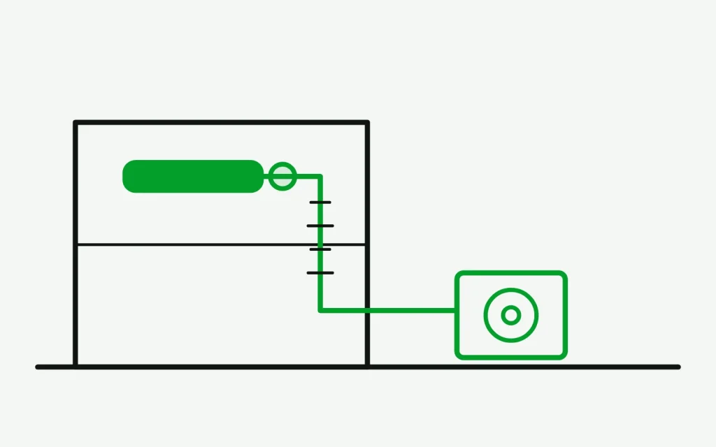 Wall-mounted ductless head with frost marks building down the lineset toward the outdoor unit